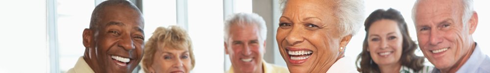 Seniors smiling around a table